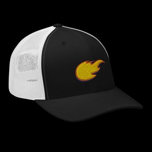 May include: Black trucker hat with a white mesh back and a curved brim. The hat features an embroidered yellow flame design with red and blue outlines on the front panel. A stylish accessory.