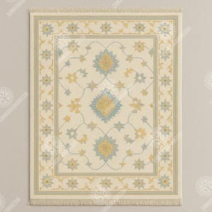 May include: Rectangular cream-colored rug with a detailed floral pattern in shades of blue and yellow. The rug features a central medallion and a border with a fringe along the bottom edge. The design is symmetrical and intricate.