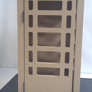 May include: A brown wooden telephone box with a crown on top and the word "TELEPHONE" written on the front.