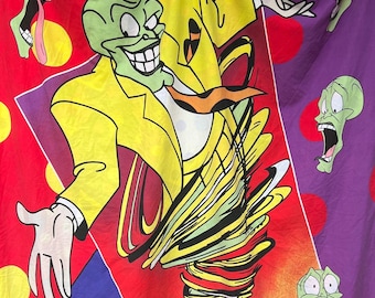 May include: A rectangular fabric wall hanging featuring a central graphic of The Mask character in a yellow suit spinning in a tornado. The background is divided into red, purple, and yellow sections with polka dots and the text SOMEBODY STOP ME! THE MASK.