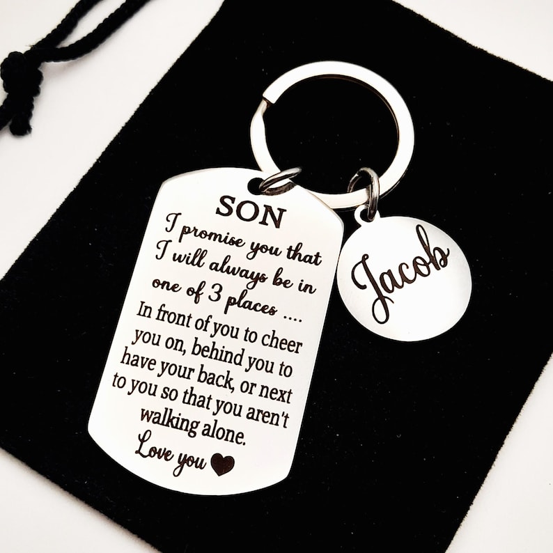 May include: Silver keychain with a tag that reads "SON I promise you that I will always be in one of 3 places... In front of you to cheer you on, behind you to have your back, or next to you so that you aren't walking alone. Love you" and a smaller tag that reads "Jacob".
