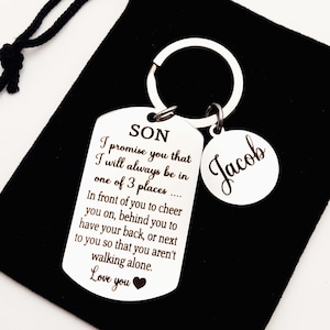May include: Silver keychain with a tag that reads "SON I promise you that I will always be in one of 3 places... In front of you to cheer you on, behind you to have your back, or next to you so that you aren't walking alone. Love you" and a round tag that reads "Jacob".