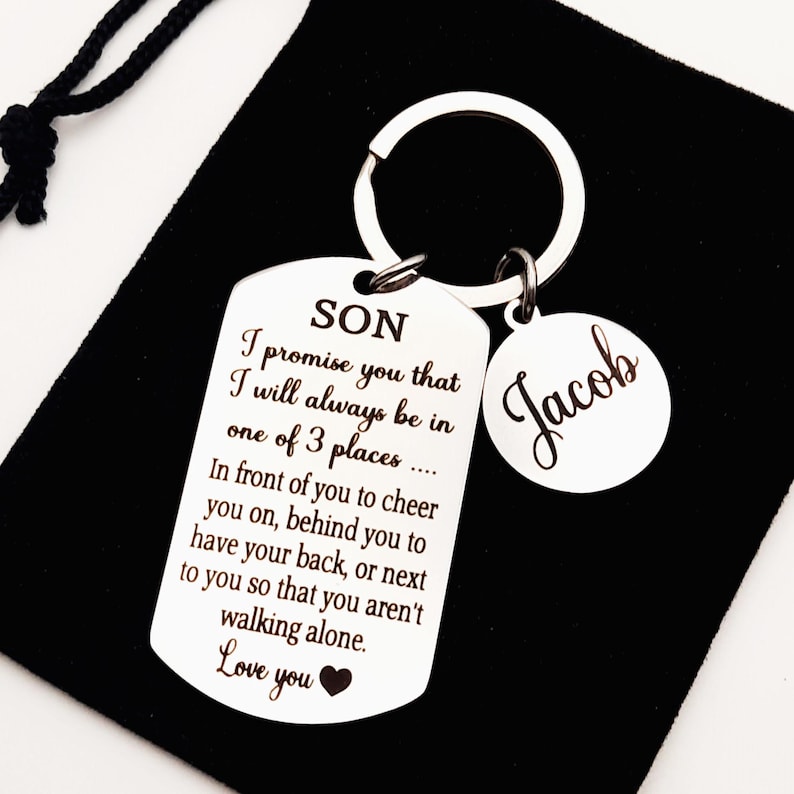 May include: Silver keychain with a tag that reads "SON I promise you that I will always be in one of 3 places... In front of you to cheer you on, behind you to have your back, or next to you so that you aren't walking alone. Love you" and a round tag that reads "Jacob".