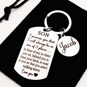 May include: Silver keychain with a dog tag that reads "SON I promise you that I will always be in one of 3 places... In front of you to cheer you on, behind you to have your back, or next to you so that you aren't walking alone. Love you" and a smaller tag that reads "Jacob".