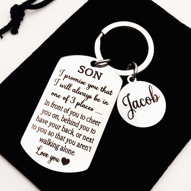 May include: Silver keychain with a tag that reads "SON I promise you that I will always be in one of 3 places... In front of you to cheer you on, behind you to have your back, or next to you so that you aren't walking alone. Love you" and a smaller tag that reads "Jacob".