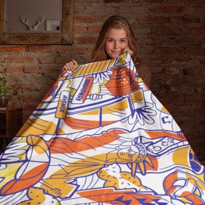 May include: A colorful throw blanket with a New York City theme. The blanket features iconic landmarks like the Statue of Liberty, Times Square, and Broadway. The blanket is made of soft, comfortable fabric and is perfect for adding a touch of New York City style to any room.