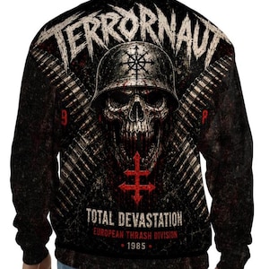 May include: A black long-sleeve sweatshirt featuring a graphic print of a skull wearing a helmet, crossed ammunition belts, and the text TERRORNAUT, TOTAL DEVASTATION, EUROPEAN THRASH DIVISION, and 1985 in white and red lettering on the back.