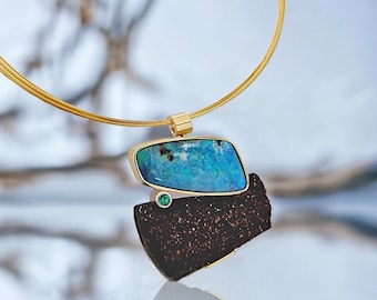 Turquoise Boulder Opal pendant with petrified wood and emerald in yellow gold and silver