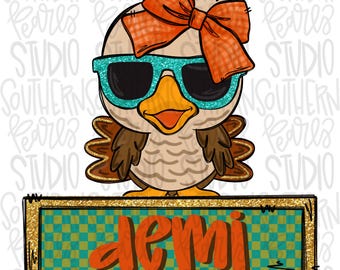May include: A cartoon turkey illustration featuring a light brown body, dark brown wings, and a large orange plaid bow on its head. The turkey wears bright teal glitter sunglasses. Below, a rectangular sign with a teal checkerboard pattern reads demi.