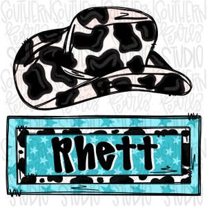 May include: A cow print cowboy hat illustration positioned above a rectangular sign with a light blue star pattern background and a black border. The sign features the name Rhett written in bold black lettering centered within the frame.