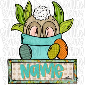 Puede incluir: Una ilustración de dibujos animados de un conejo color canela con una cola blanca esponjosa que asoma de una maceta azul claro. El conejo está rodeado de hojas verdes y dos huevos de Pascua estampados. Debajo de la maceta hay un letrero rectangular con la palabra Name en color verde azulado.