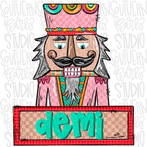 May include: A colorful illustration of a nutcracker with a pink and checkered uniform, a black mustache, and a gray beard. The nutcracker wears a decorative hat with rainbow accents. The name "Demi" is displayed on a rectangular sign below.