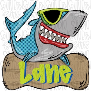 May include: A cartoon shark wearing sunglasses and a toothy grin, sitting on a brown wooden sign with the name "Lane" written in green letters.