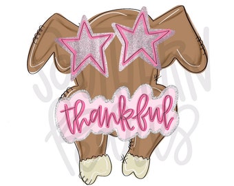May include: A brown turkey illustration featuring pink glitter star-shaped glasses and a pink cloud-shaped sign with a silver glitter border that displays the word thankful in a cursive pink font, with light cream-colored feet at the bottom.