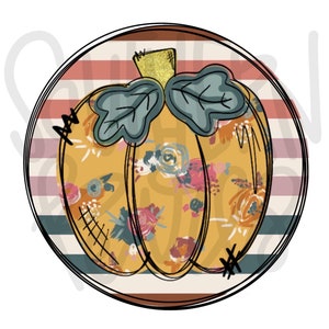 Puede incluir: Un fondo redondo a rayas de color naranja, azul y blanco con una calabaza amarilla con un patrón floral y un tallo verde.