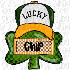 May include: A graphic illustration featuring a white and green trucker hat with the word LUCKY in black text. Below the hat is a green shamrock shape with a rectangular orange and white checkered banner containing the black text Chip.