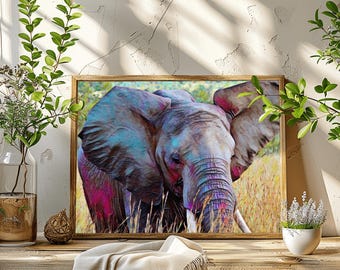 May include: A framed art print of an elephant with a colorful, artistic design. The elephant is depicted with shades of blue, pink, and purple, set against a backdrop of tall grass. The artwork is displayed on a wooden surface.