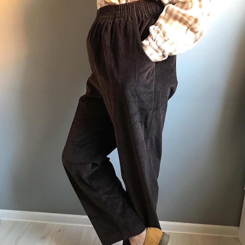 May include: Brown corduroy pants with a wide leg and an elastic waistband.
