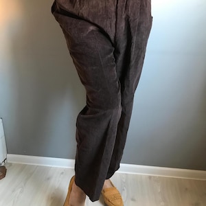 May include: Brown corduroy pants with a wide leg and elastic waistband.