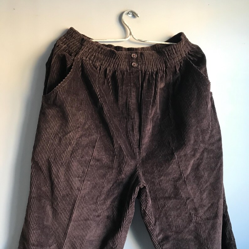 May include: A pair of brown corduroy pants with a wide leg and a button fly.