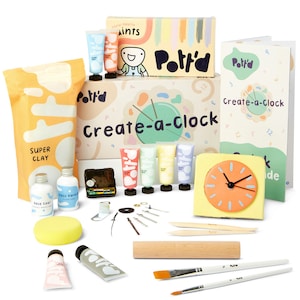 May include: A craft kit labelled "Create-a-Clock" with art supplies. Includes clay, paints, brushes, clock hands, and a clock face. The kit features the brand name "Pott'd" and is designed for creative projects.