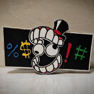 May include: A black and white cartoon character with a red hat and a big smile. The character is peeking over a black sign with the symbols %, $, !, and #.