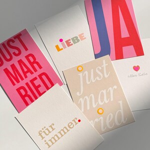 May include: Five different cards with various wedding-themed messages. The cards are all white with colorful text and designs. The messages include "Just Married", "Liebe", "Just Married", "f&uuml;r immer", and "Ja".