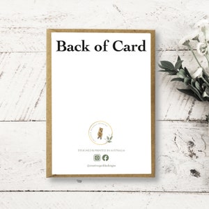 May include: Back of a card with the text "Back of Card" printed in black at the top. The bottom of the card features a gold circle with a cartoon quokka and the text "Creativity of Quokka Designs". Below the circle is the text "Designed & Printed in Australia" and social media icons for Instagram and Facebook. The text "@creativequokkadesigns" is printed below the icons.