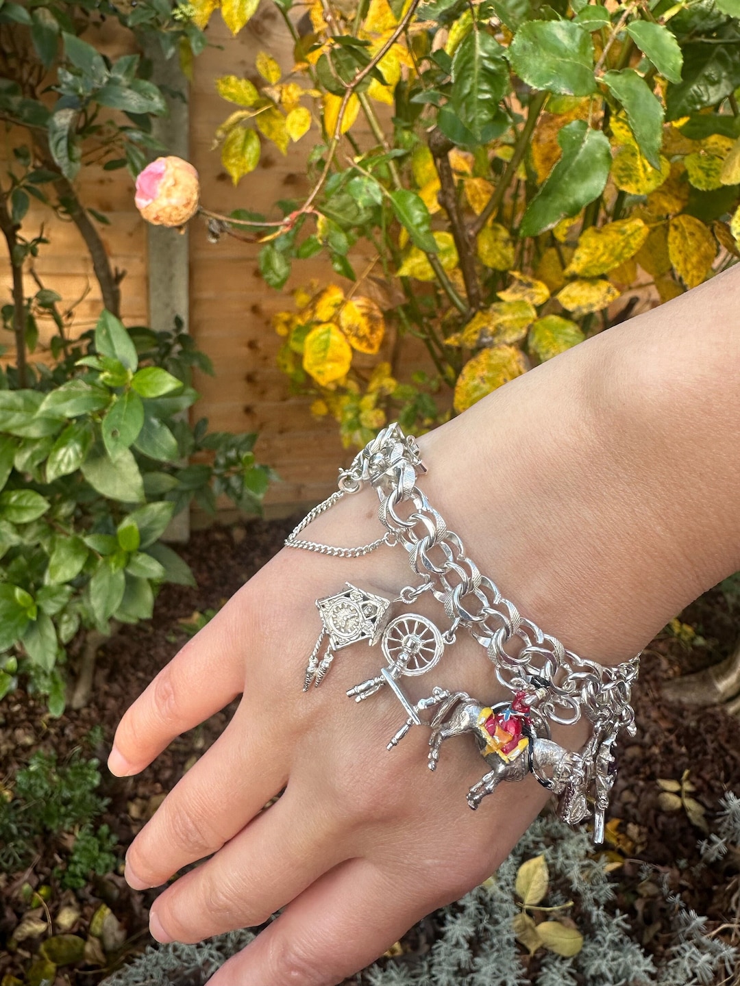 An 117g AGC Silver Charm Bracelet of 15 Charms With Intact Safety