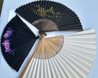 A Collection of Vintage Chinese Black and White Paper Folding Fans in Different Sizes