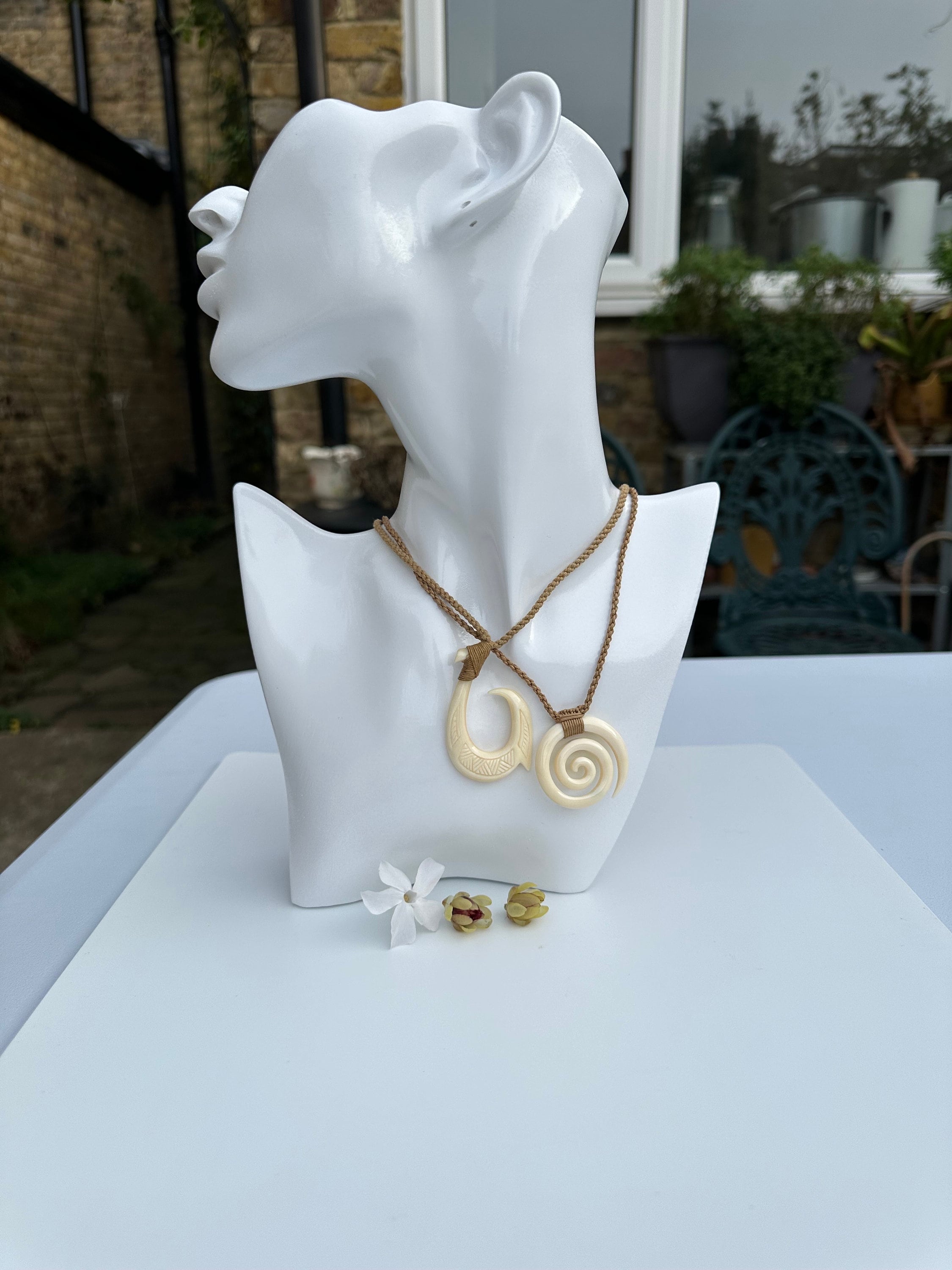 A Maori Engraved Bone Hei Matau Fish Hook Pendant Necklace and A Maori ...