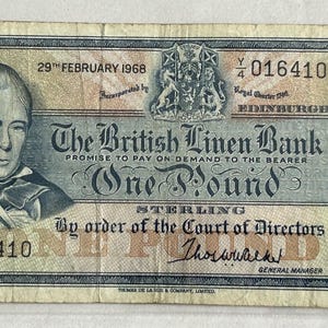 Peut inclure: Un billet de banque vintage d'une livre sterling de la British Linen Bank, daté du 29 février 1968. Le billet présente un portrait d'homme, le texte The British Linen Bank, One Pound, et le numéro de série Y/4 016410, avec des armoiries et des bordures.