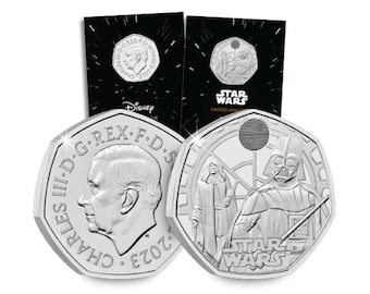 May include: Silver Star Wars commemorative coins. One coin features Darth Vader and other characters, with the Star Wars logo. The other coin shows King Charles III. The packaging includes the Disney logo and the words "Star Wars United Kingdom".