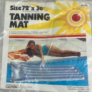 May include: A blue and white inflatable tanning mat with a reflective silver bottom. The mat is 72 inches by 30 inches. The package includes a warning that the mat is not a lifesaving device and should not be overinflated.