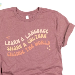 Learn a language share a culture change the world Spanish Teacher Shirt Bilingual Teacher Dual Language Instruction Teacher Tee