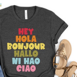 Hey Hola Bonjour Hallo Ni Hao Ciao Retro Greetings Tee Spanish Teacher Shirt Bilingual Teacher Dual Language Instruction Teacher Tee Dark Grey Heather