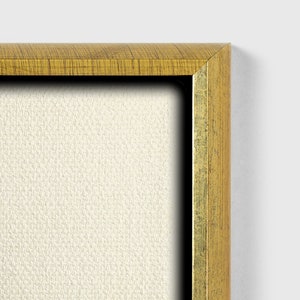 May include: Close-up of the top right corner of a gold-colored picture frame. The frame has a wood grain texture and a slightly raised edge.