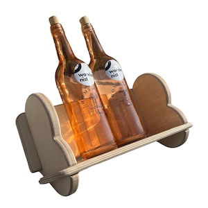 May include: Two bottles of wine on a wooden shelf with a heart-shaped design. The bottles are labeled "Wonderist" and "Home Made Natural Wine".
