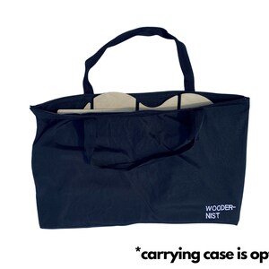 May include: A black canvas tote bag with the text "WOODER-NIST" printed on the front. The bag is open and appears to be empty.
