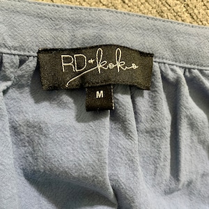 May include: A blue cotton garment with a black tag that reads "RD+koko" and a size label that says "M".