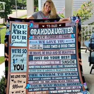 May include: A blue and brown blanket with a message for a granddaughter. The message reads "You are our sunshine. Never forget that we love you. Life is filled with hard times and good times. Be brave, be bold and be beautiful. Just do your best. Keep your face to the sunshine and you cannot see the shadows. Life isn't about waiting for the storm to pass. It's about learning to dance in the rain. Enjoy the ride and never forget your way back home. We didn't give you the gift of life. Life gave us the gift of you. With love and kisses, Grammy and Pappy."