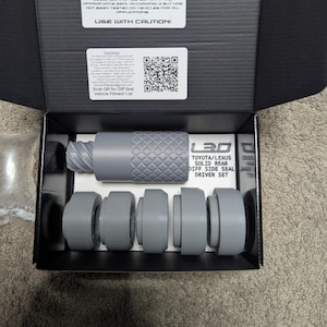 May include: A gray LEXTREME3DESIGNS Toyota/Lexus Diff Side Seal Driver Set in an open black box. The set includes a textured cylindrical tool and several gray circular pieces. The box has a warning label and a QR code.