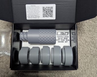May include: A gray LEXTREME3DESIGNS Toyota/Lexus Diff Side Seal Driver Set in an open black box. The set includes a textured cylindrical tool and several gray circular pieces. The box has a warning label and a QR code.