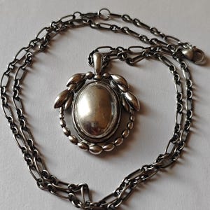 George Jensen sterling silver pendant with original chain.