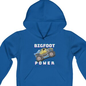 May include: A royal blue hooded sweatshirt with a cartoon monster truck graphic and the text "BIGFOOT POWER" in white.