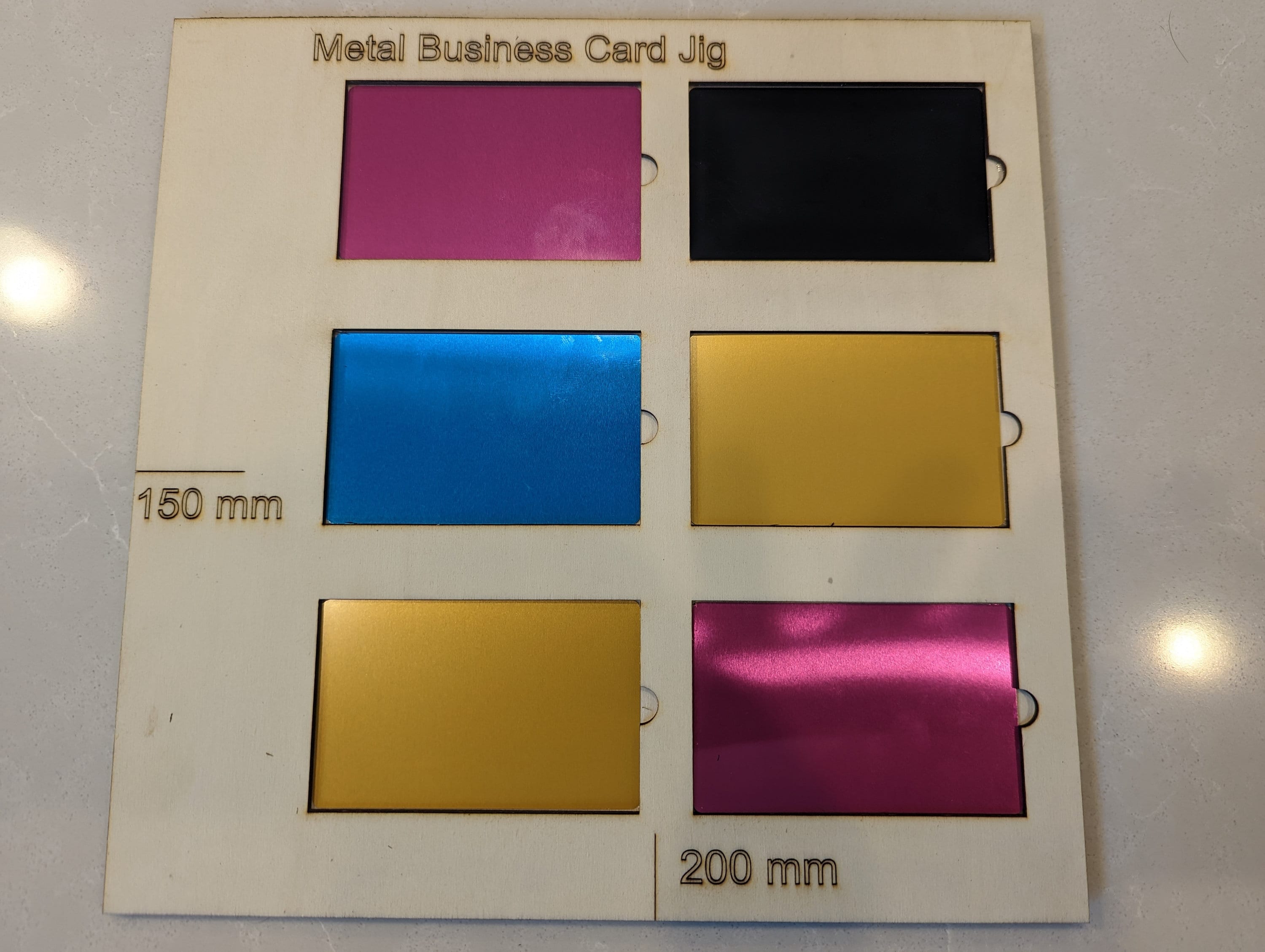 Engraved metal business cards made using the bizcard jig