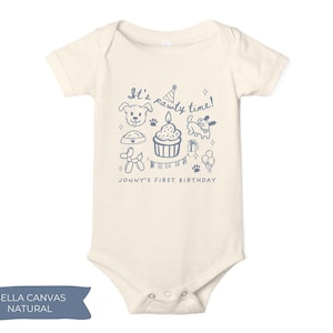 May include: A cream-colored baby onesie with a blue graphic that reads "It's pawty time!" and "Jonny's first birthday." The design includes a dog, cupcake, balloons, and other party-themed illustrations. The onesie is made of Bella Canvas Natural fabric.