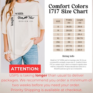 May include: Cream-colored t-shirt with a size chart for Comfort Colors 1717. The chart lists sizes S to 4XL, with width and length measurements in inches. The shirt has the "Ouma Design Co." logo. The image also includes sizing information.