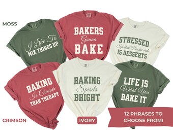 May include: Twelve different t-shirt designs with baking-themed phrases. The shirts are in various colors, including moss green, crimson red, ivory white, and olive green. The phrases include "I Like To Mix Things Up", "Bakers Gonna Bake", "Stressed Spelled Backwards Is Desserts", "Baking Is Cheaper Than Therapy", "Baking Spirits Bright", "Life Is What You Bake It".