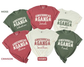 May include: Five t-shirts in different colors with the text "Gingerbread Gang" and a gingerbread man graphic. The shirts are in the colors crimson, moss, ivory, and two shades of green.